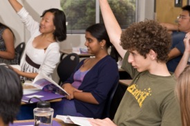 Gifted Students Raising Their Hands In A Classroom